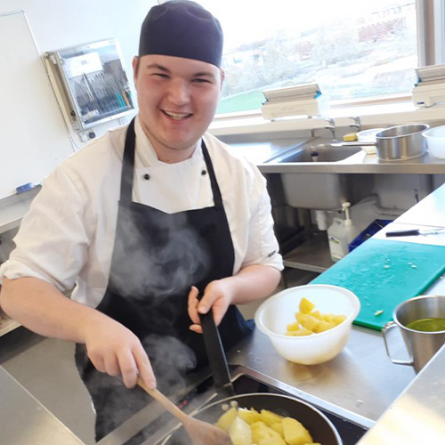 student cooking in kitchen