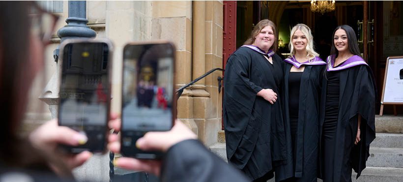 A group of UHI Inverness graduans smiling to the camera having their photo taken A group of UHI Inverness graduans smiling to the camera having their photo taken
