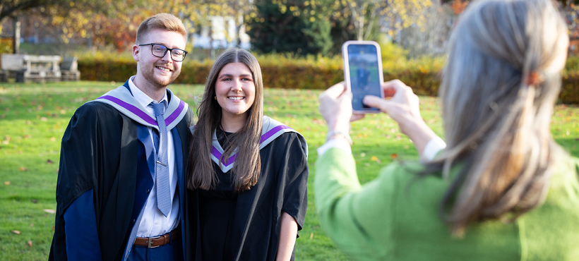 UHI Inverness graduans smiling to the camera having their photo taken UHI Inverness graduans smiling to the camera having their photo taken