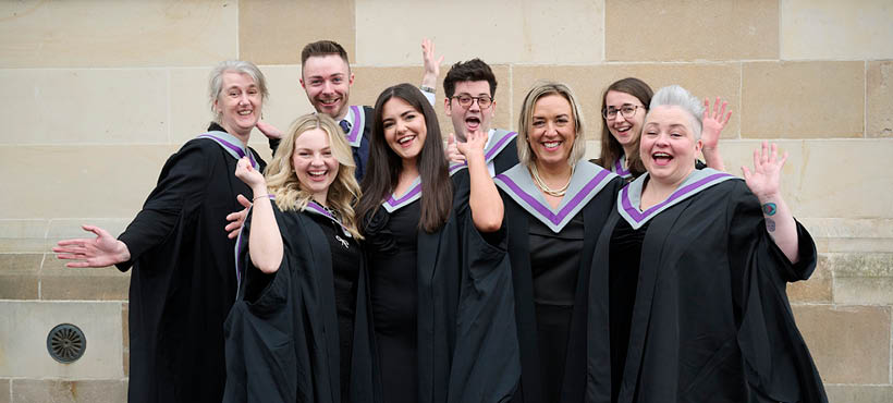Group of UHI Inverness students smiling and waving to camera