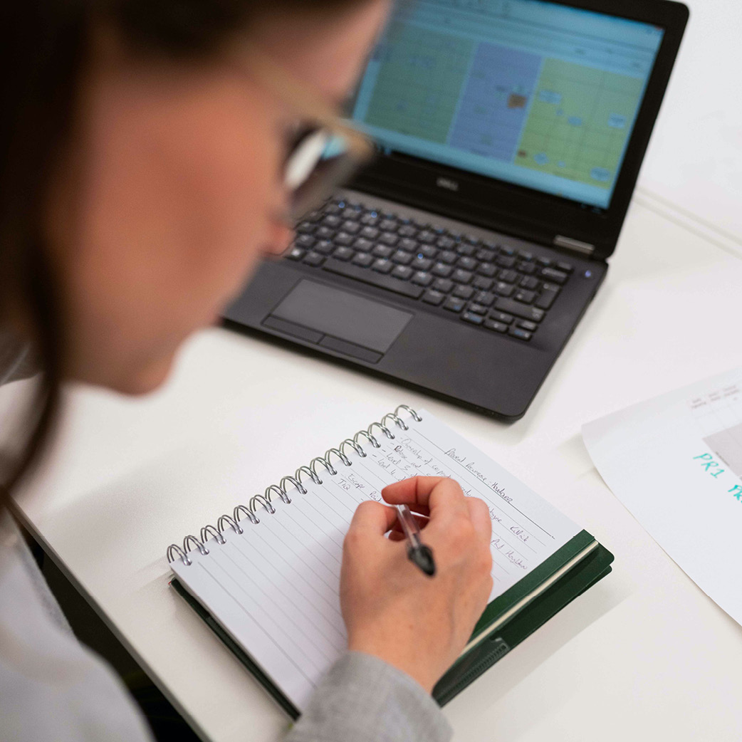 A person writing in a notebook