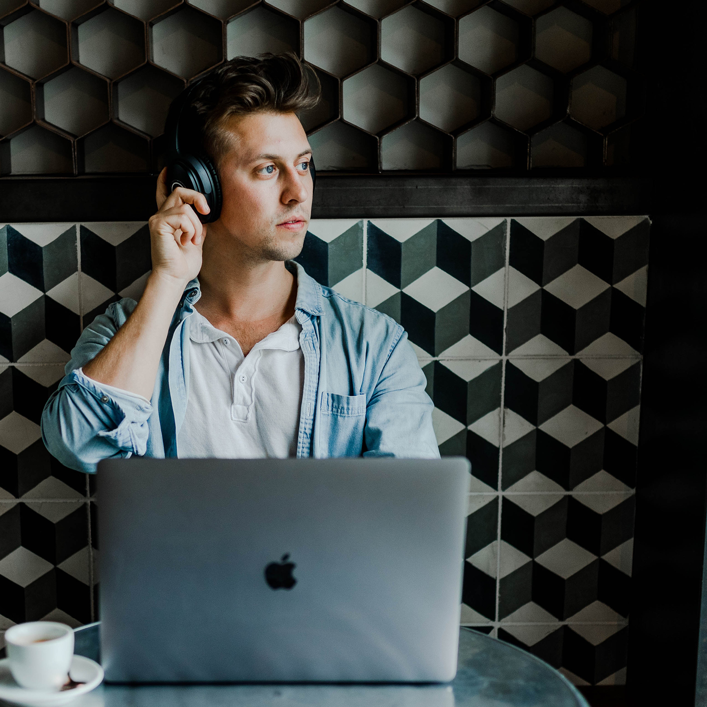Person using a laptop and headphones