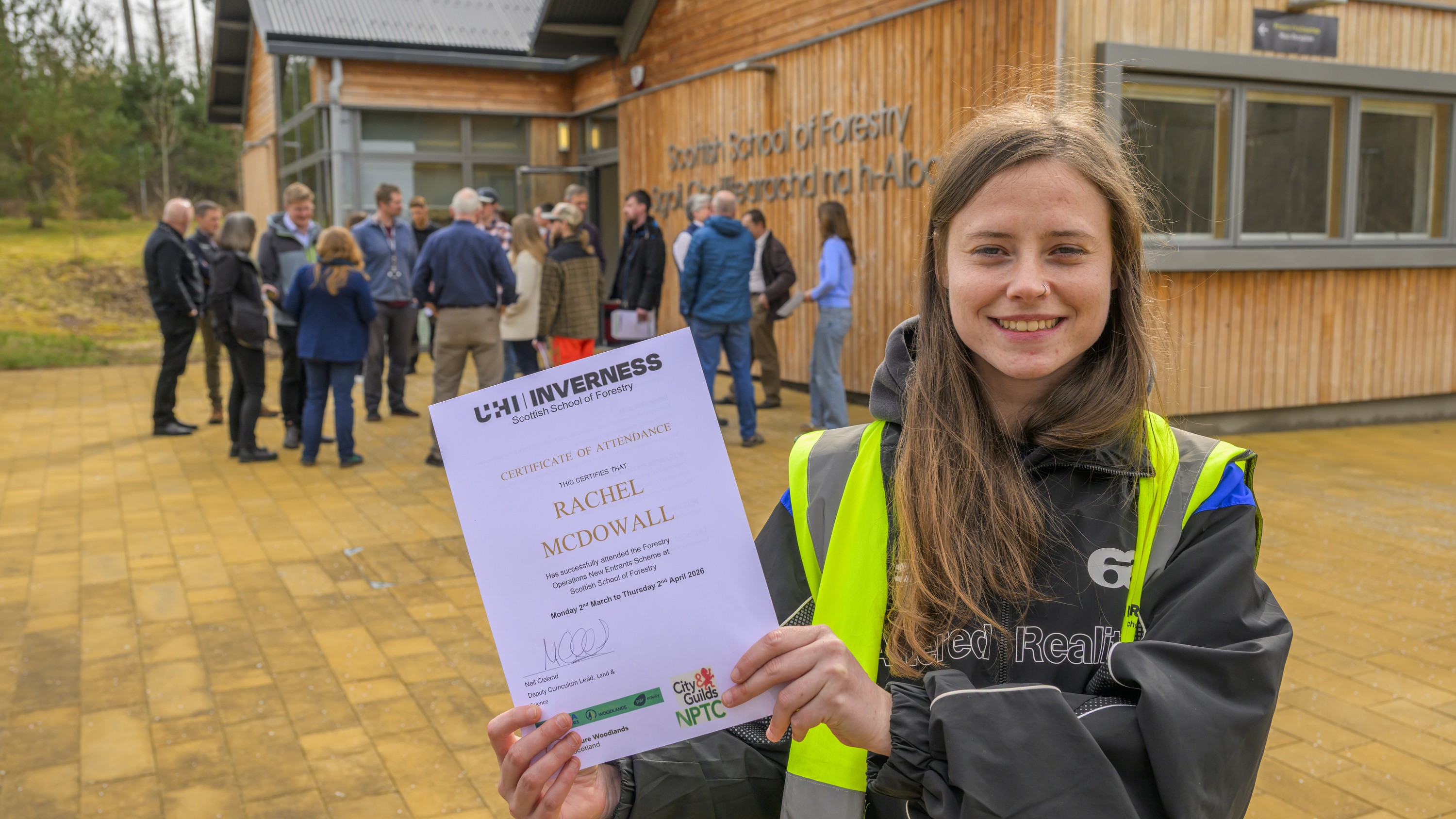 Female student holding a certificate