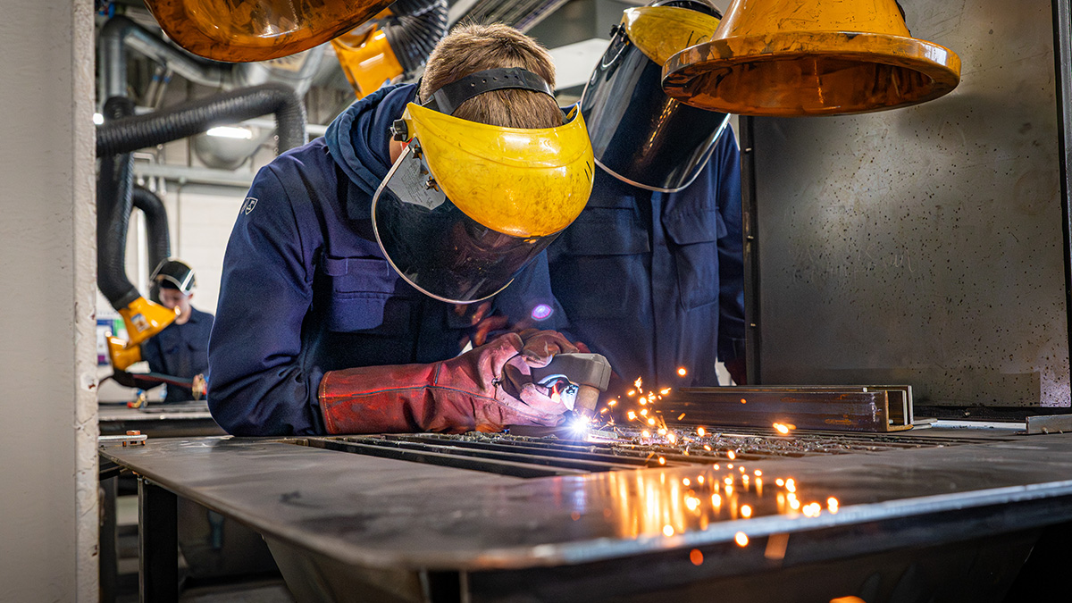 Two welding students with masks Two welding students with masks