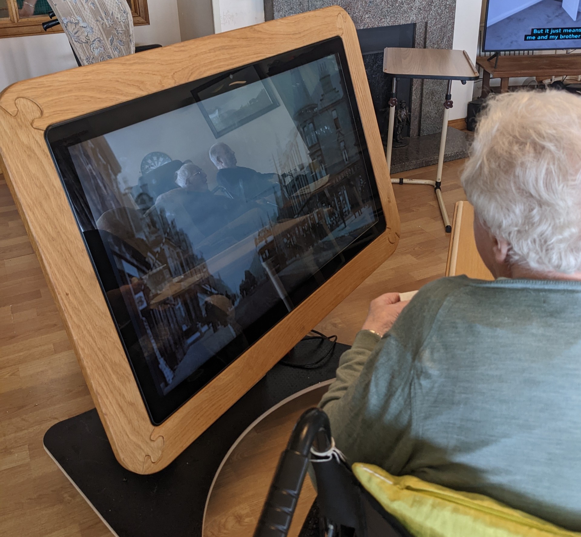 Person sitting on a wheelchair watching TV Person sitting on a wheelchair watching TV
