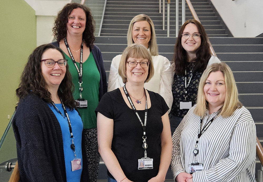 Education Support Advisers posing on stairs