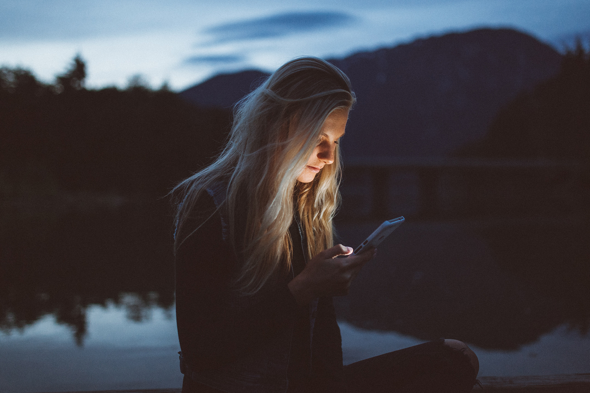 Person on a shore looking at their phone