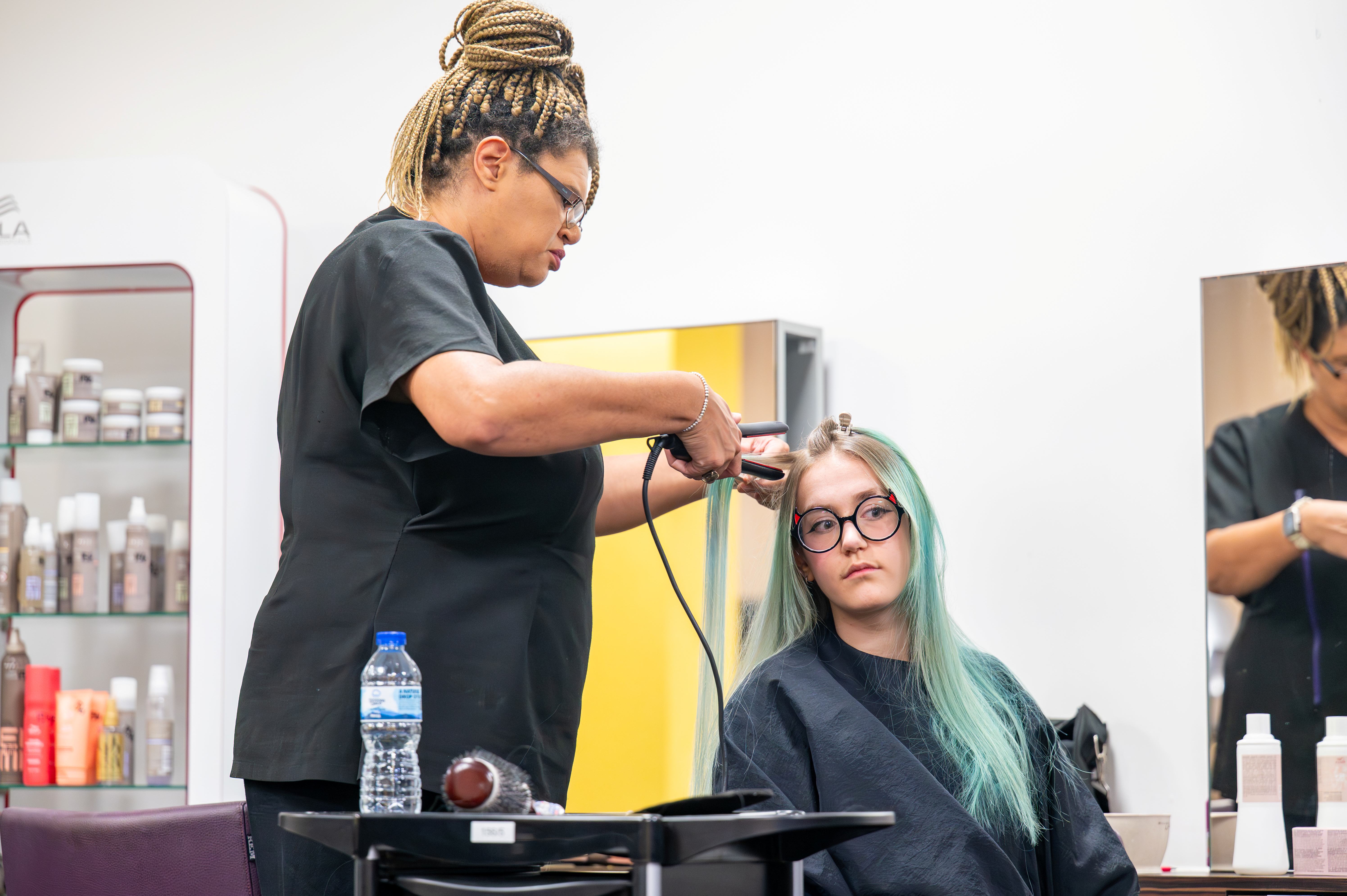 Students working on straightening hair