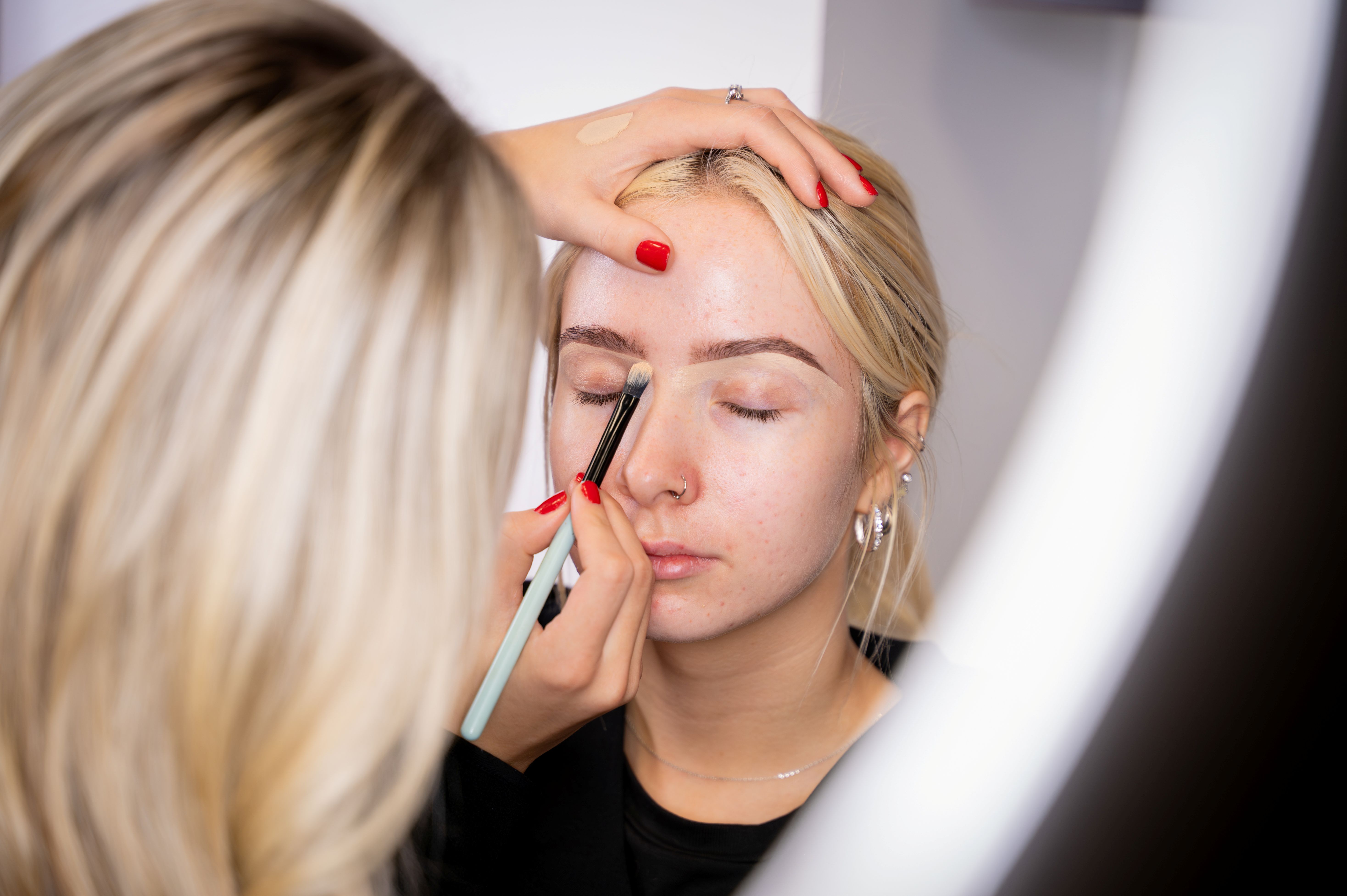 Student getting her make up done